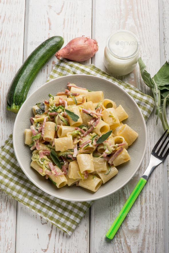 pasta with speck zucchinis and cream sauce Stock Photo by